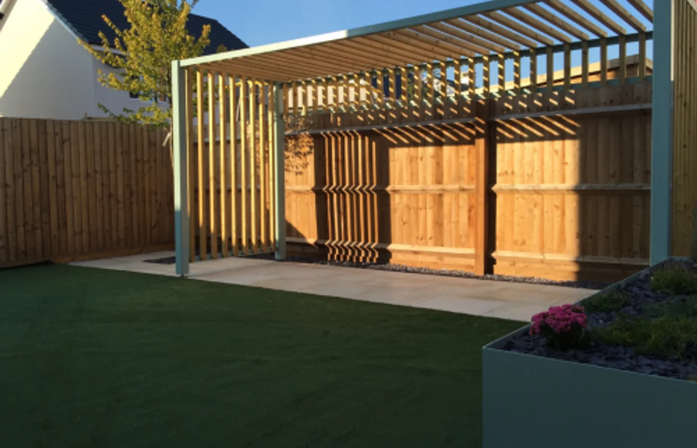 Bioclimatic aluminium pergola with partly open louvered roof over patio dining