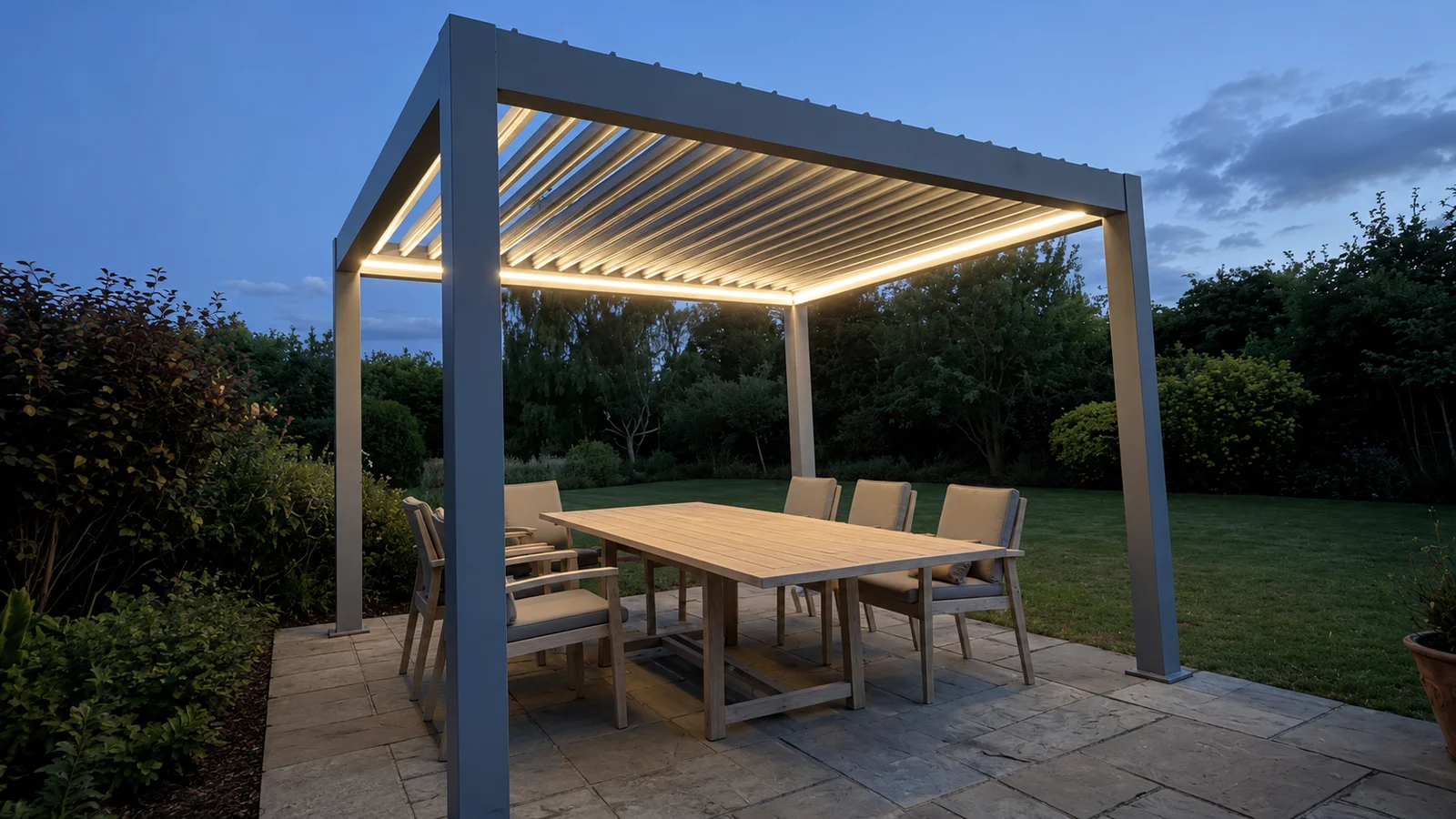 Contemporary aluminium pergola with louvered roof over patio dining in a Bedfordshire garden